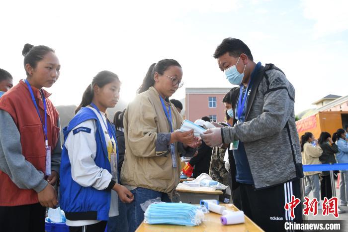 7月7日，考生在拉薩三高考點外領(lǐng)取口罩?！『闻罾?攝